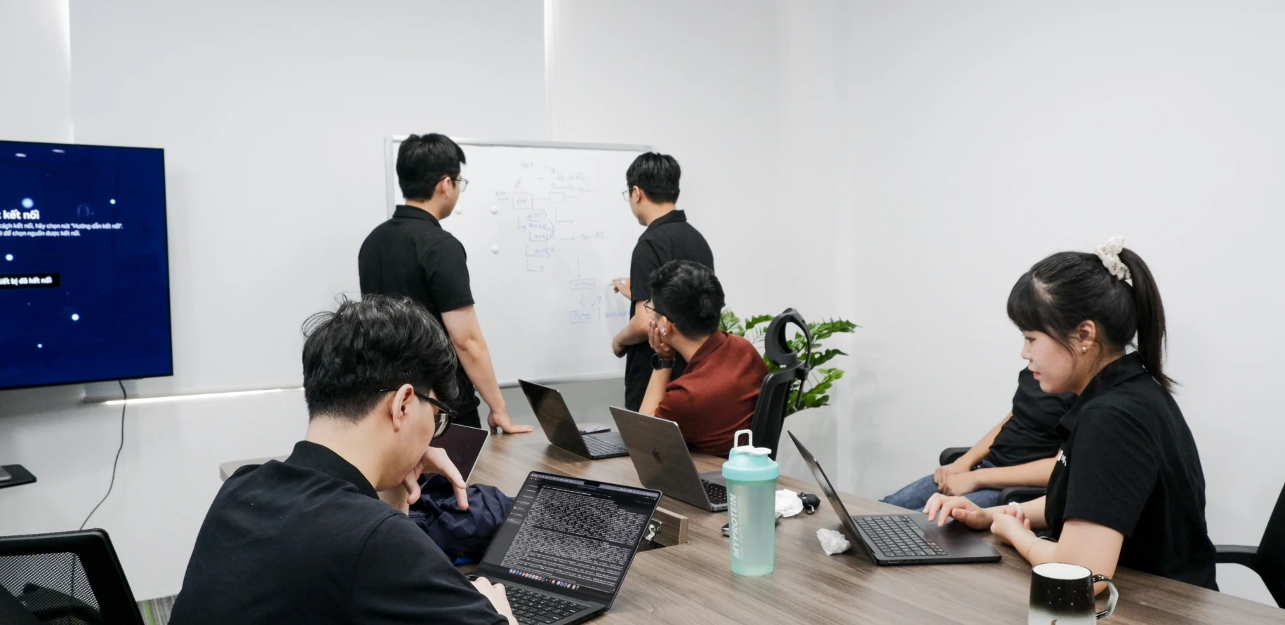 Spartan engineers collaborating around a whiteboard